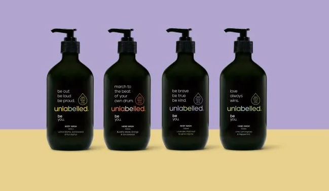 Product image of Unlabelled body care range that embrace's Gen Alpha's desire for self-expression. 4 black bottles are lined up against a purple and background. 